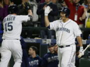 Seattle&#039;s Kyle Seager (15) is greeted by Dae-Ho Lee, right, after Seager hit a two-run home run during the seventh inning Thursday. (Ted S.