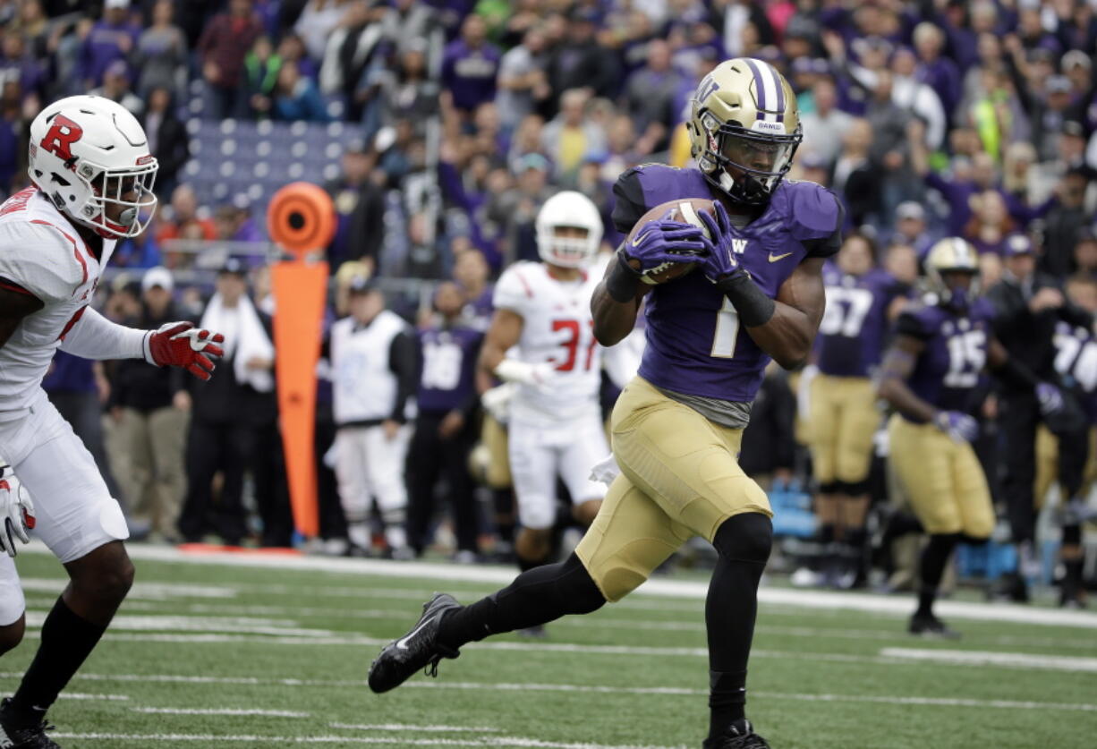 Washington&#039;s John Ross scores on a 50-yard pass against Rutgers in the first half of an NCAA college football game, Saturday, Sept. 3, 2016, in Seattle.