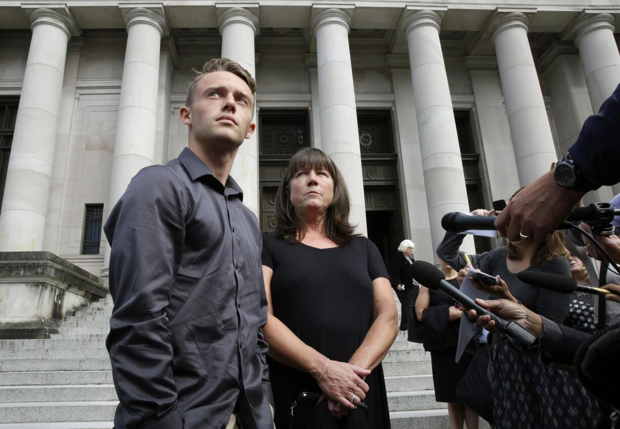 Stephanie McCleary, right, and her son Carter McCleary, 17, left, talk to reporters Wednesday, Sept. 7, 2016, in Olympia, Wash., following a Washington State Supreme Court hearing on the ongoing battle surrounding the state's constitutional requirement to properly fund basic education. Stephanie McCleary is one of the plaintiffs in the case. (AP Photo/Ted S.