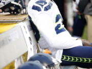 Seahawks cornerback Jeremy Lane sits as the national anthem plays before last week&#039;s game in Oakland.