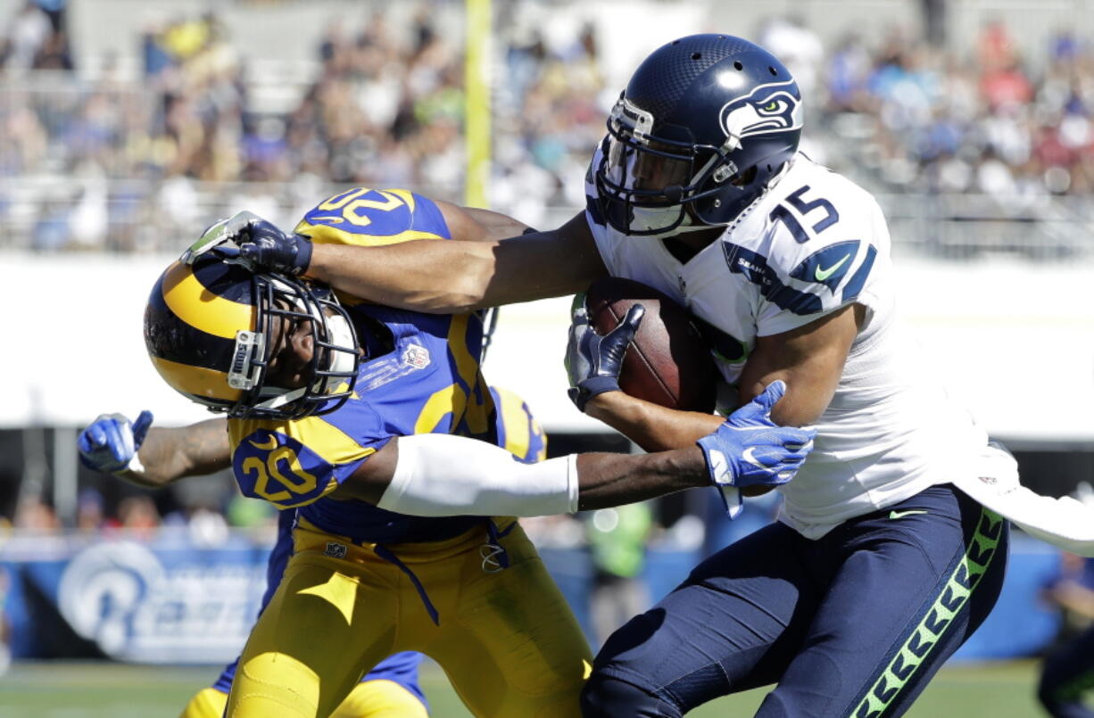 Seattle Seahawks wide receiver Jermaine Kearse, right, pushes Los Angeles Rams cornerback Lamarcus Joyner away as he runs the ball during the second half of an NFL football game at the Los Angeles Memorial Coliseum, Sunday, Sept. 18, 2016, in Los Angeles.