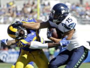 Seattle Seahawks wide receiver Jermaine Kearse, right, pushes Los Angeles Rams cornerback Lamarcus Joyner away as he runs the ball during the second half of an NFL football game at the Los Angeles Memorial Coliseum, Sunday, Sept. 18, 2016, in Los Angeles.