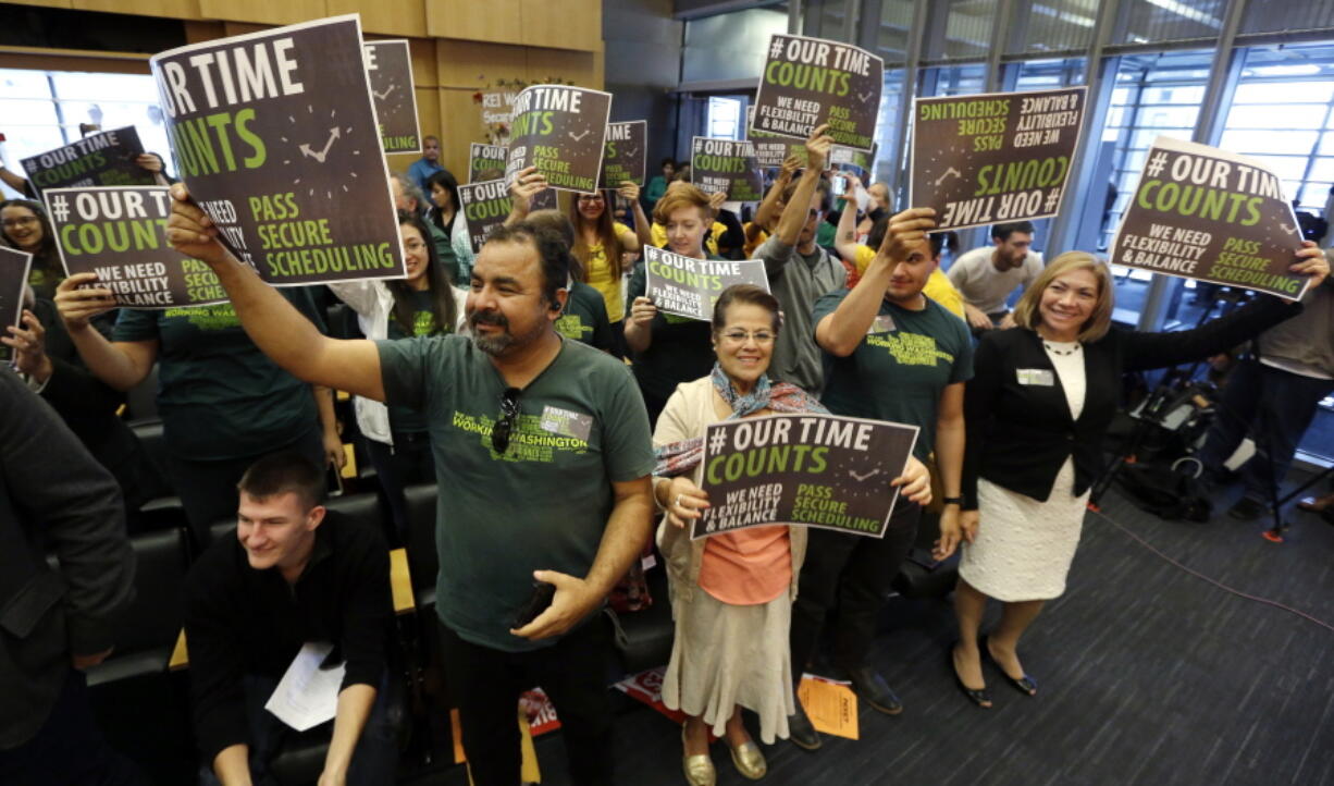 Supporters cheer as the Seattle City Council unanimously approved a new law designed to give hourly retail and food-service workers more predictability in their scheduling Monday in Seattle.