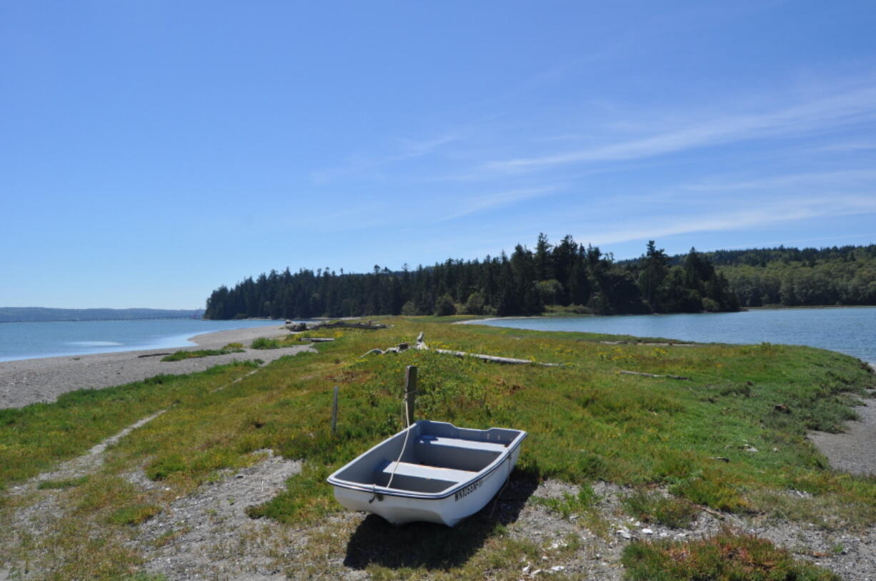 This Aug. 12, 2016 photo, a boat rests on the Wolfe Property near Port Ludlow, Wash.  The unofficial state park known as the Wolfe Property near Port Ludlow, Wash. sits just north of the Hood Canal bridge on the Olympic Peninsula. The property features a warm water bay, large lagoon and nearly 200 forested acres.