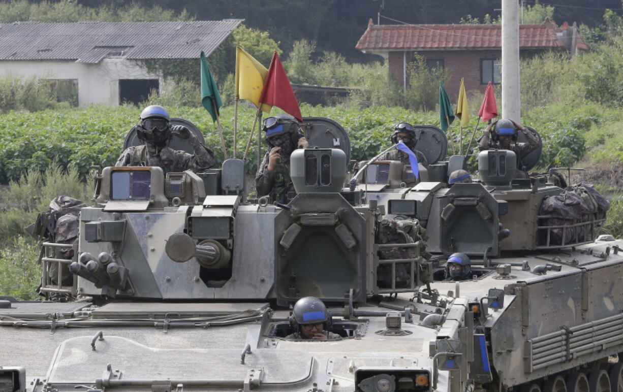 South Korean army soldiers ride their armored vehicles Sunday during an annual exercise in Paju, South Korea, near the border with North Korea. South Korea is on edge after North Korea conducted its fifth nuclear test Friday.