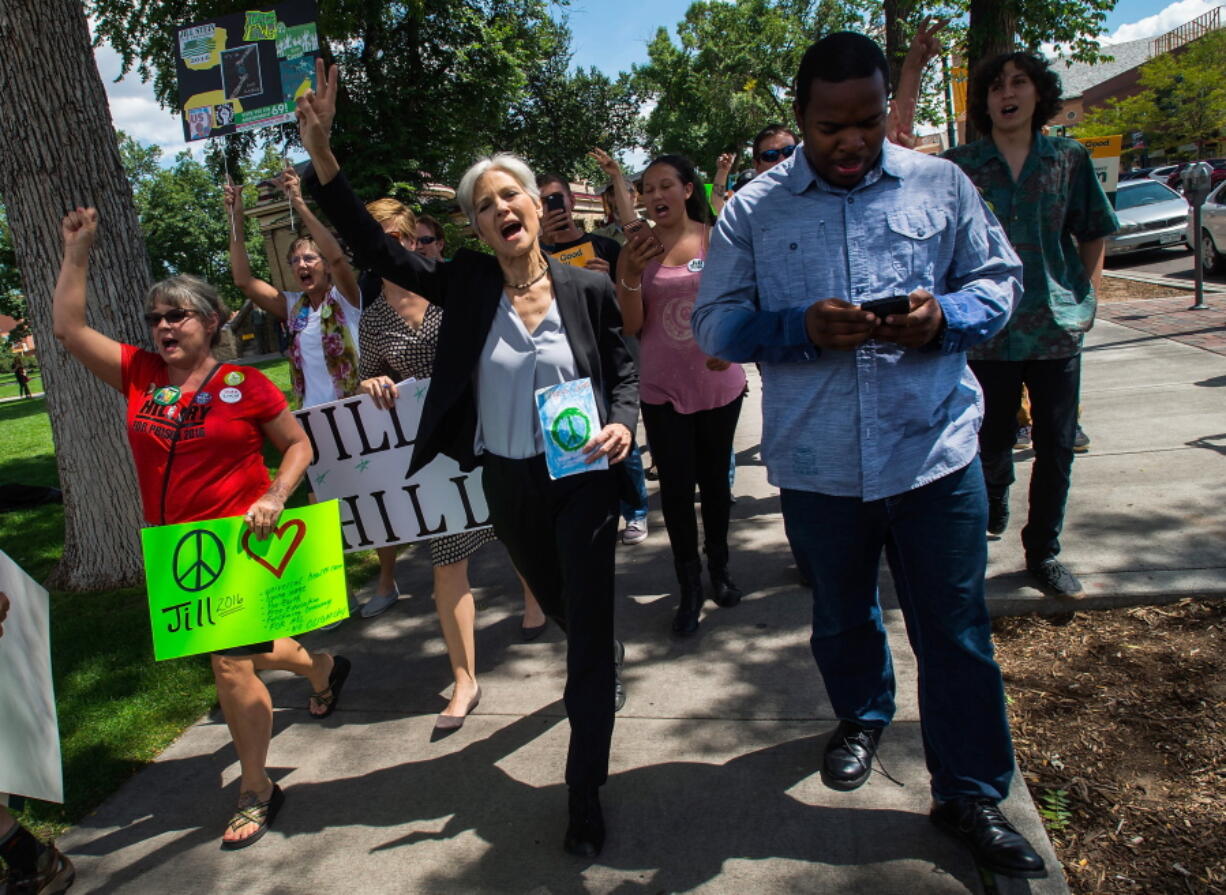 Green Party presidential candidate Jill Stein, center, marches with supporters Saturday through Acacia Park in Colorado Springs, Colo., where she spoke after a rally.