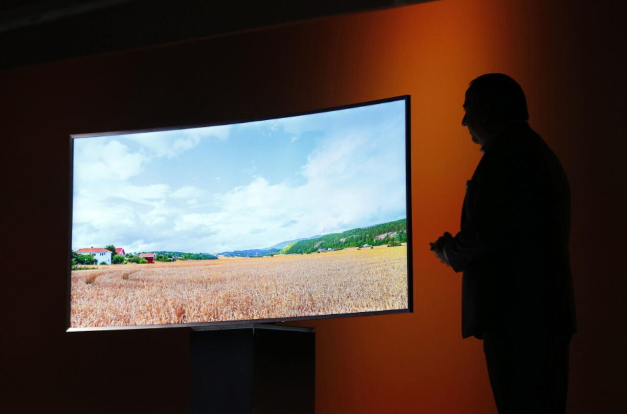 Joe Stinziano, executive vice president of Samsung Electronics America, introduces a Samsung SUHD 4K TV at a news conference Jan. 5, 2015 in Las Vegas. An environmental group is accusing a trio of major TV makers of engineering their sets to make them look more energy efficient than they actually are.