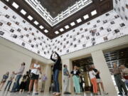 Visitors to the George W. Bush Presidential Library and Museum look upwards at a 360 degree video screen showing a video welcoming them to the center in Dallas on May 1, 2013.