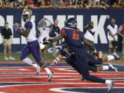 Washington wide receiver John Ross, left, scores a touchdown against Arizona during the first half of an NCAA college football game, Saturday, Sept. 24, 2016, in Tucson, Ariz.