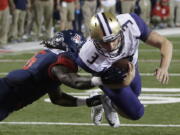 Washington quarterback Jake Browning (3) dives into the end zone with Arizona safety Demetrius Flannigan-Fowles hanging on during the second half of an NCAA college football game, Saturday, Sept. 24, 2016, in Tucson, Ariz. Washington defeated Arizona 35-28 in overtime.