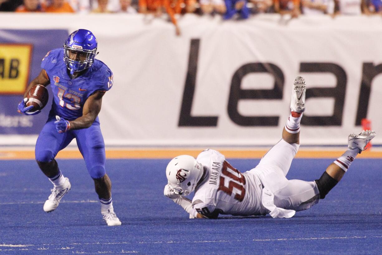 Boise State running back Jeremy McNichols (13) runs the ball past Washington State defensive linesman Hercules Mata'afa (50) during the second half of an NCAA college football game in Boise, Idaho, on Saturday, Sept. 10, 2016.