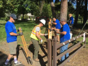 Hudson&#039;s Bay: Members of the veterans group The Mission Continues work to replace part of a fence at Fort Vancouver on Sept.