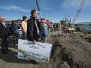 Stephen Mileham of LRS Architects, center, holds artists&#039; renderings of the future Vancouver Waterfront while joining a tour of the construction site Wednesday afternoon.