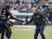 Seattle Seahawks head coach Pete Carroll celebrates with cornerback Richard Sherman (25) during the first half of an NFL football game against the New York Jets Sunday, Oct. 2, 2016, in East Rutherford, N.J.