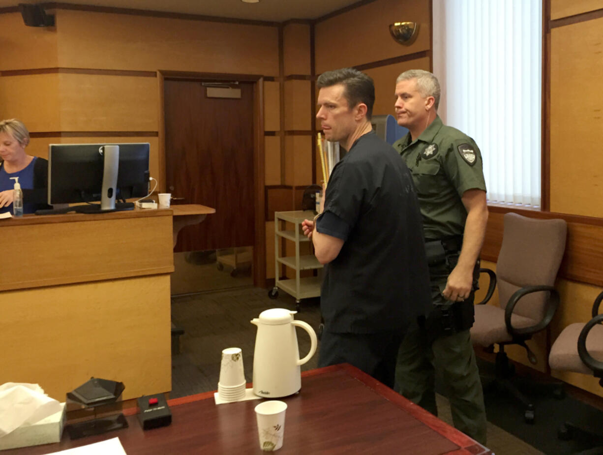 John Garrett Smith is escorted out of a Clark County courtroom in December 2014 after Superior Court Judge Robert Lewis found him guilty. The Washington Court of Appeals has overturned Smith&#039;s attempted-murder conviction, but upheld an assault conviction.