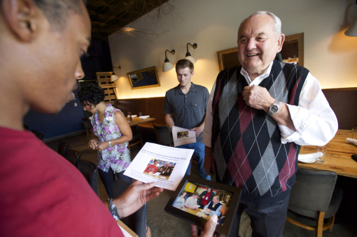 Longtime Lunch Buddy Steve Runyun greets Isaiah Ephraim at Lapellah for a grown-up lunch in 2015. Runyan met with his three lunch buddies who all attended low-income King Elementary, and now have graduated from three local high schools.