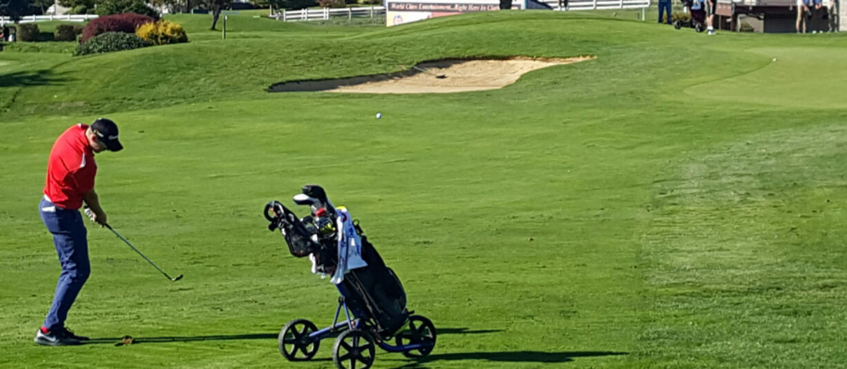 Spencer Tibbits of Fort Vancouver hits an approach shot on his way to a 25-shot win at the 3A district tournament.