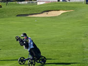 Spencer Tibbits of Fort Vancouver hits an approach shot on his way to a 25-shot win at the 3A district tournament.