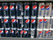 Pepsi drinks are on display at a market in Palo Alto, Calif.