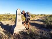 Jeff Garmire of Vancouver rests at the southern terminus of the Continental Divide Trail in New Mexico.