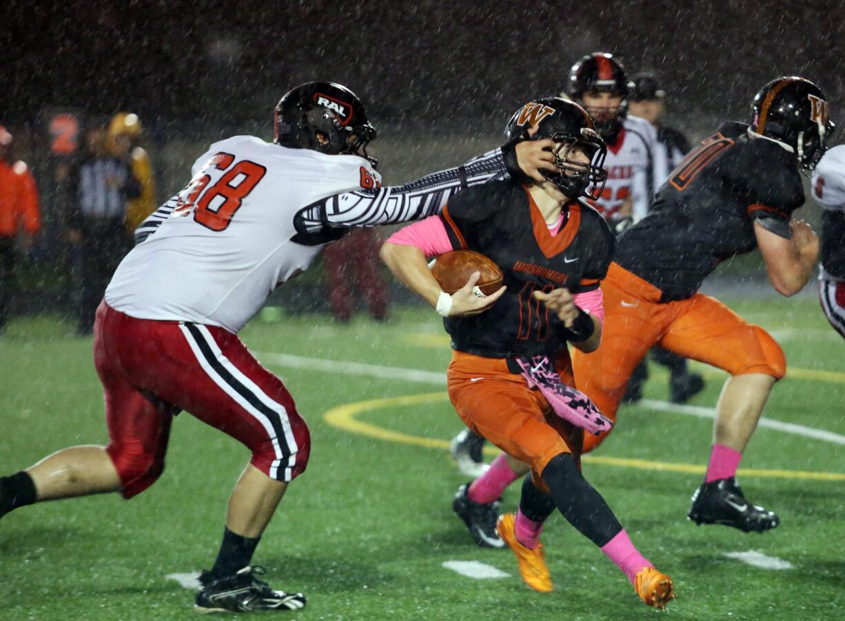 RA Long Lumberjack Keoni Mawae grabs the face-mask of Washougal Panther Ryan Stevens at a game in Washougal Friday October 21, 2016.