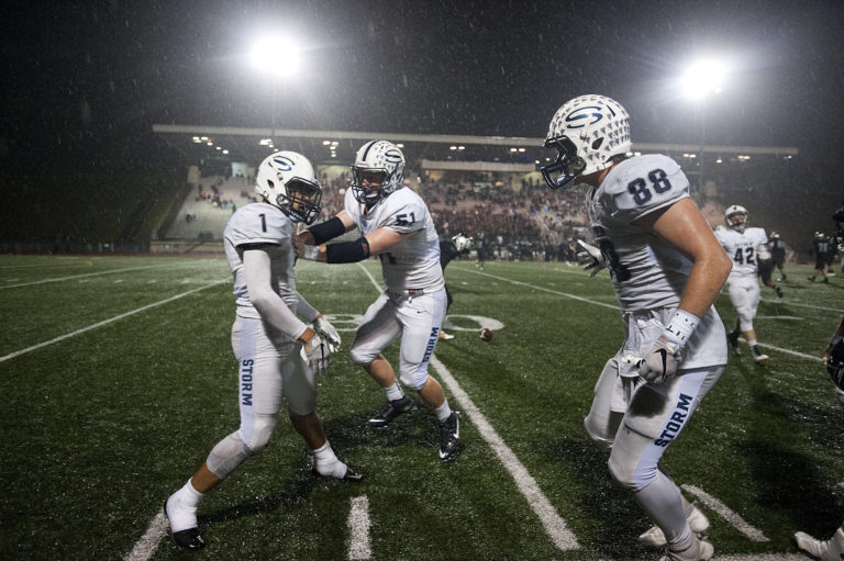 Skyview's Angelo Sarchi (1), Michael Lundgren (51) and Skyler Martin (88) celebrate an interception in the second half at McKenzie Stadium on Friday night, Oct. 21, 2016.