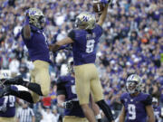 Washington&#039;s John Ross, left, and Dante Pettis leap to celebrate Pettis&#039; touchdown against Oregon State in the first half of an NCAA college football game Saturday, Oct. 22, 2016, in Seattle.