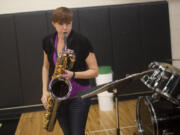 Bryana Steck plays bari sax while leading the pep band Thursday in the Woodland gymnasium during the Beavers&#039; volleyball win over Columbia River.