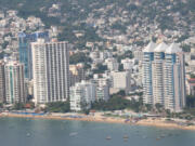 Gleaming beachside hotels and residences on Acapulco Bay -- seen from a distance -- suggest a sense of jet-set glamour. At night, the view is spectacular as ever.