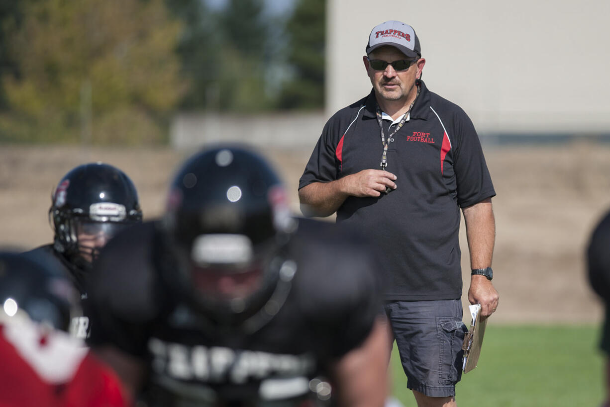 Fort Vancouver High School head coach Cal Szueber keeps an eye on the action during practice Wednesday afternoon, August 26, 2015 at his team's practice field.