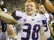 Washington Hayden Schuh (38) celebrates with his team after an NCAA college football game Saturday, Oct. 8, 2016, in Eugene, Ore. Washington beat Oregon 70-21.