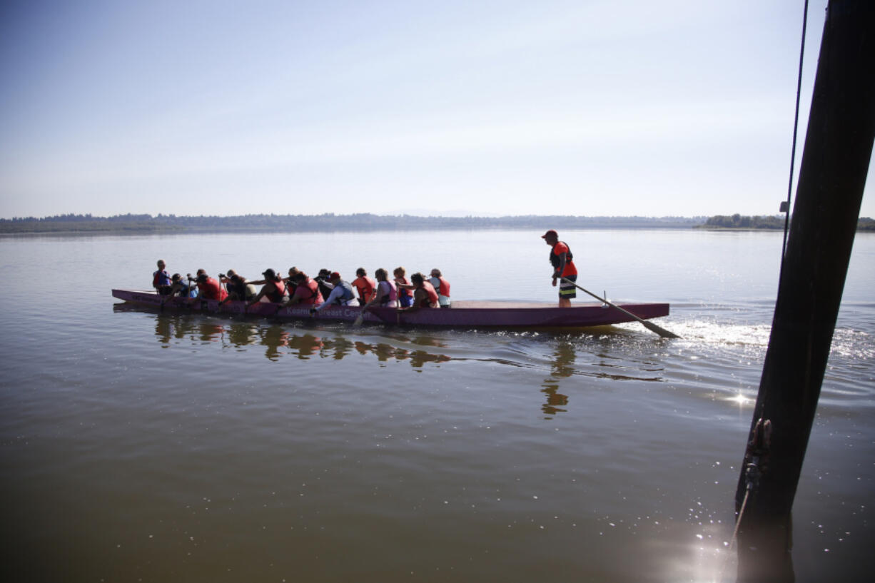 The Vancouver Lake Crew women&#039;s dragon boat team Catch-22 practices in the PeaceHealth Kearney Breast Center boat at Vancouver Lake.