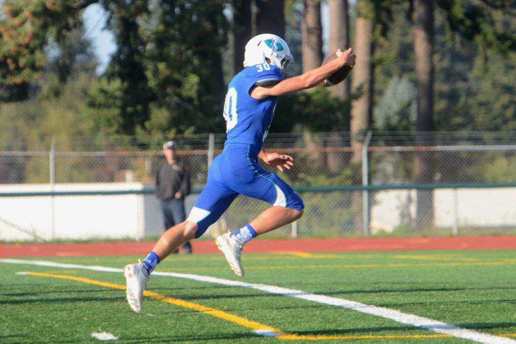 Mountain View running back Jack Mertens bounds into the end zone during a game against Hudson's Bay at McKenzie Stadium on Friday, September 30, 2016. Mountain View beat Hudson's Bay 34-16.