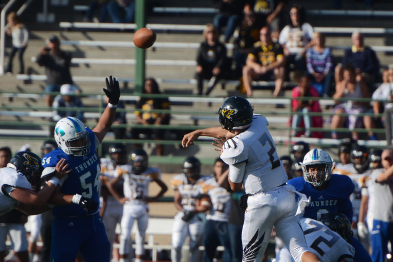 Hudson's Bay quarterback Jordan Hickman heaves the ball over Mountain View defensive lineman Thai Hindman at McKenzie Stadium on Friday, September 30, 2016. Mountain View beat Hudson's Bay 34-16.