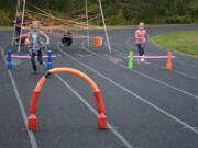 Washougal: Cape Horn-Skye Elementary School students Kiana Evans, left, and Jenevieve Neibuhr compete in the Kodak Ninja Warrior Challenge, which raised more than $3,000 for a new playground structure.