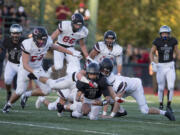 Union&#039;s Lincoln Victor (5) loses control of the ball in the second quarter at McKenzie Stadium on Friday night, Oct. 28, 2016. Camas went on to recover the ball.