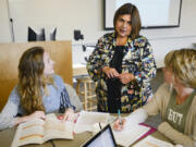 Professor Gisela Ernst-Slavit, center, helps education students during an Introduction to English-Language Learners course Monday at Washington State University Vancouver. WSU received a $2.2 million grant to put more than 50 bilingual teachers in classrooms in Vancouver and the Tri-Cities.