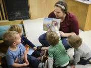 Mariah Laidlaw reads to toddlers Thursday morning at the Central Park Child Care Center in Vancouver. The Central Park center is one of 29 centers making up the Clark County Child Care Consortium.