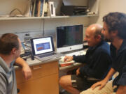 From left, Washington State Vancouver scientists Nikolay Strigul, Stephen Henderson and Jean Liénard discuss a collaborative project that uses photographs rather than laborious measurements to map aquatic vegetation.