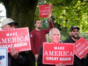 Donald Trump supporters hold signs at the Trump for president rally at Esther Short Park on Sunday.