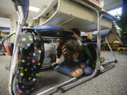 Emma Corado, a fourth-grader in Julie Menor&#039;s class at Prune Hill Elementary School, hides under her desk with classmates during an earthquake drill Thursday.