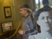 An etched-glass portrait of a woman watches guests leave the O.O. Howard House on Sunday during the Spirit Tales walking tour around Officers Row and the West Barracks.