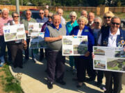 Father Blanchet Park: Members of the Fort Vancouver Lions Club and Evergreen Habitat Humanity go over building plans for the 10-home McKibbin Commons affordable housing development, which the Lions will help build.