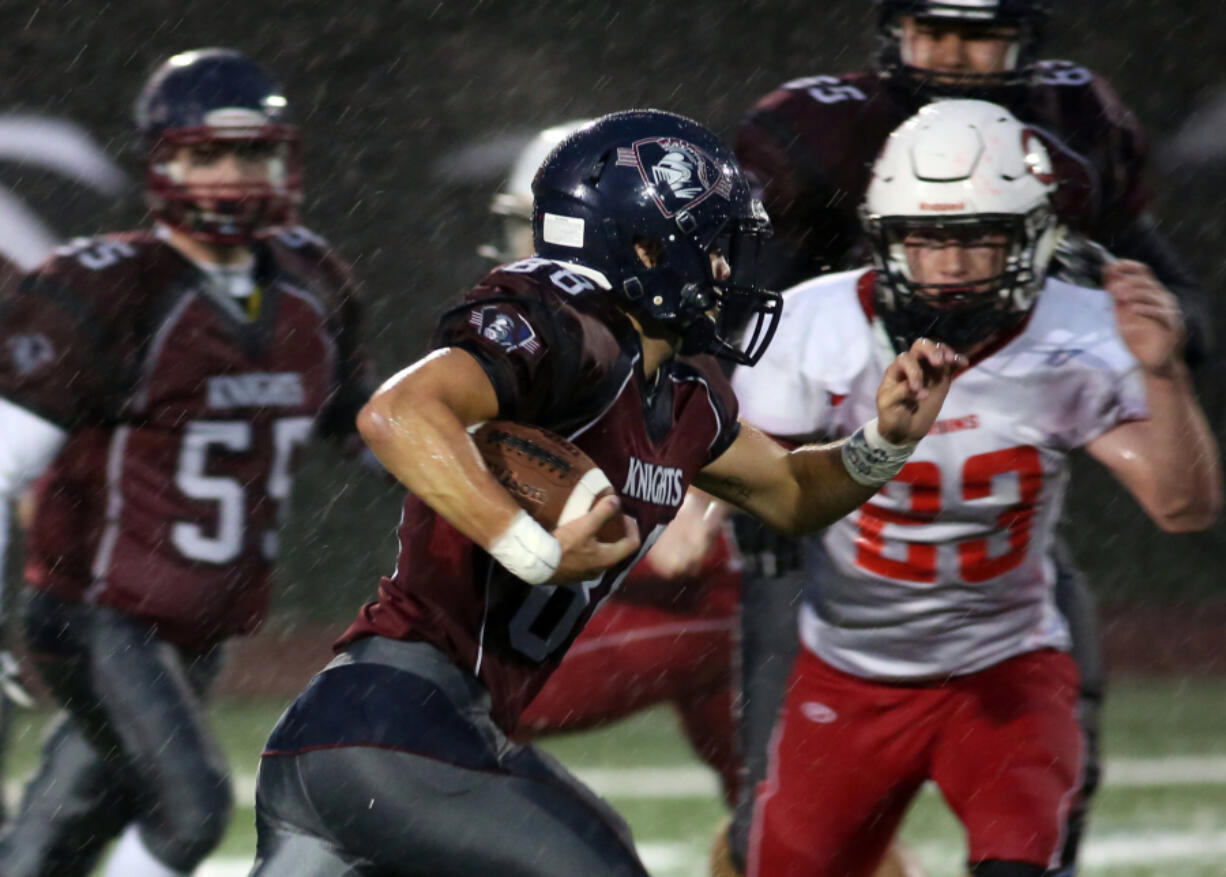 King&#039;s Way Christian&#039;s Jonathan Stell (L) runs with the ball eluding Columbia&#039;s Zachary Walker (23) at a football game in Vancouver Friday October 14, 2016.