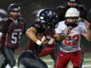 King&#039;s Way Christian&#039;s Jonathan Stell (L) runs with the ball eluding Columbia&#039;s Zachary Walker (23) at a football game in Vancouver Friday October 14, 2016.