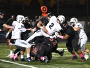 Skyview quarterback Brody Barnum (2) is stopped by Camas defenders during Friday’s game at Doc Harris Stadium. Camas won 31-9.