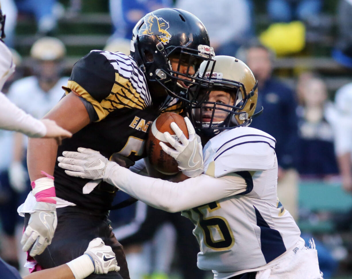 Hudson Bay's Akilotoa Kamatule is tackled by a Kelso Highlander Bryce Miller during a football game at the Kiggins Bowl in Vancouver Friday, Oct. 28, 2016.