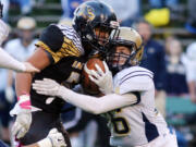 Hudson Bay's Akilotoa Kamatule is tackled by a Kelso Highlander Bryce Miller during a football game at the Kiggins Bowl in Vancouver Friday, Oct. 28, 2016.