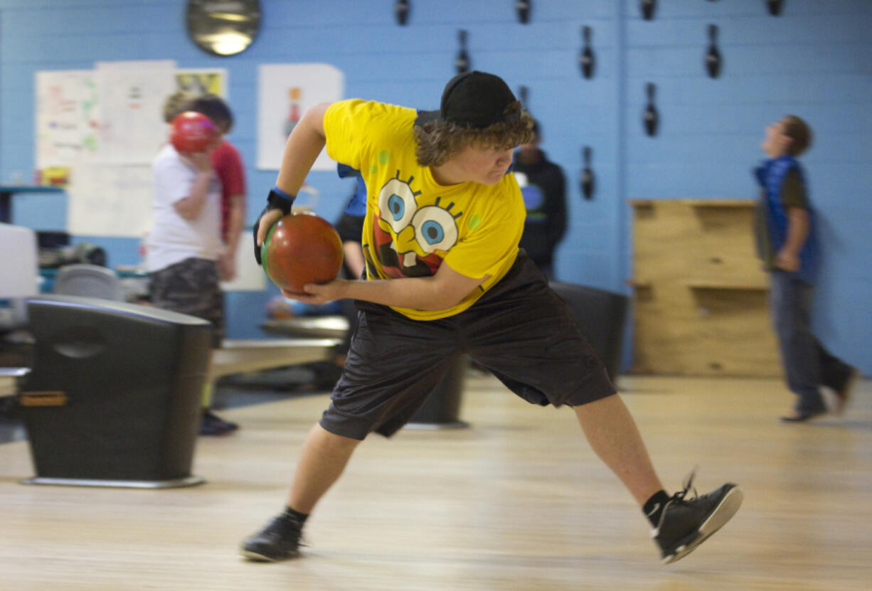 Eleventh-grader Matthew Peterson hurls a ball down a bowling lane Sunday at the Spooktacular Fun party at Bailey&#039;s Tiger Bowl in Battle Ground. The Halloween party, organized by the Prevent Together Battle Ground Prevention Alliance, included a free afternoon of bowling and pizza.