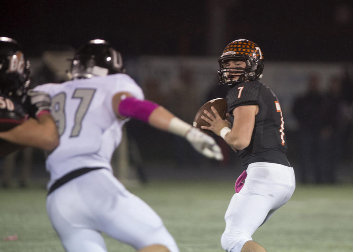 Battle Ground&#039;s Gunner Talkington, right, looks for an open teammate while under pressure in the second quarter at Battle Ground High School on Friday night, Oct. 7, 2016.